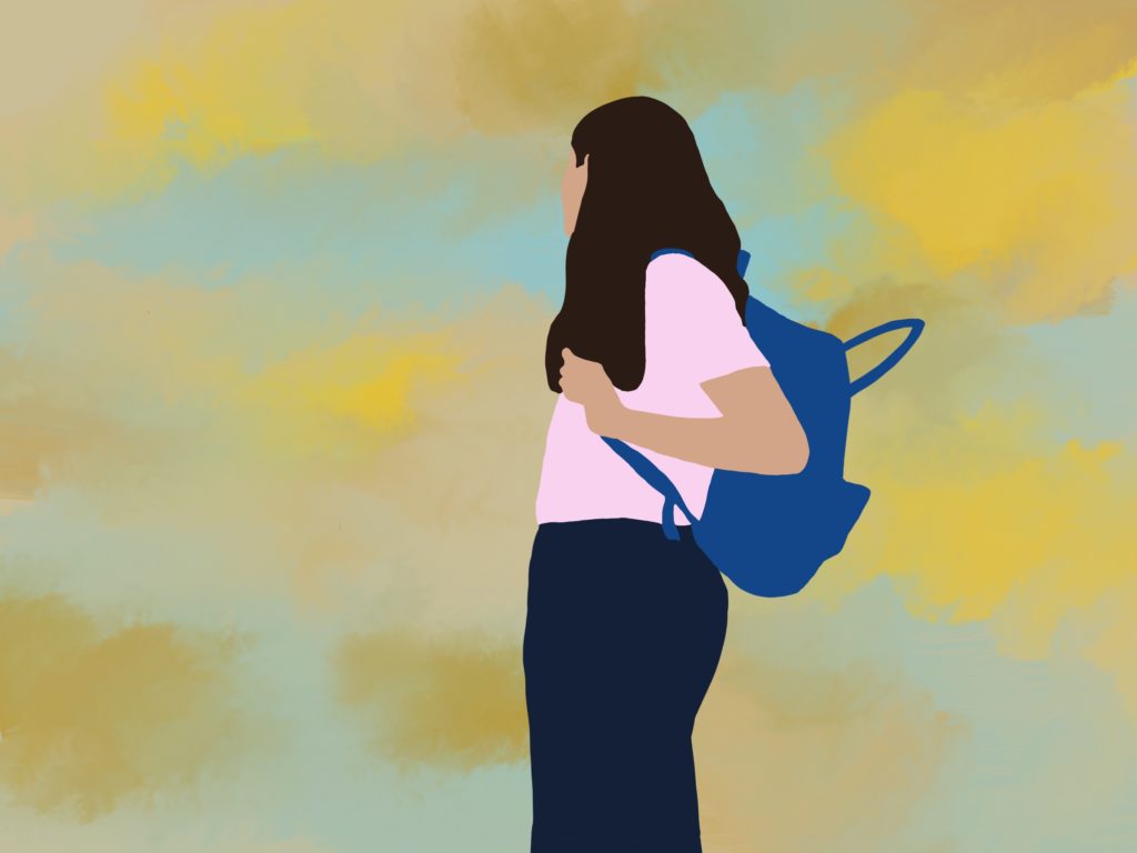 girl with backpack looking into the sunset